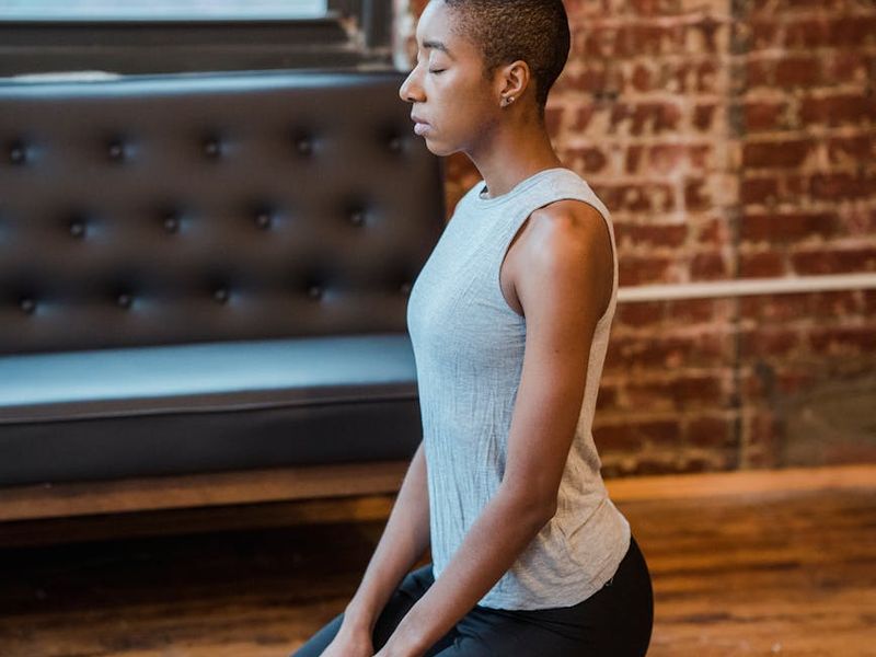 Clean, open living room with a yoga mat on the floor, ready for a workout.